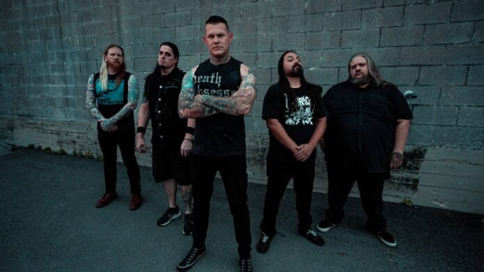 Carnifex press photo Carnifex band members posing in front of a cinder block wall