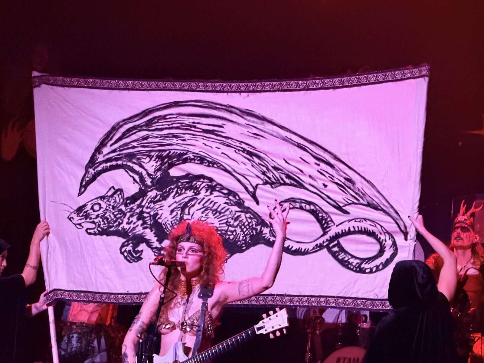 Castle Rat unfurl a banner scroll of the Castle Rat behind Riley Pinkerton at Belasco Theater, Los Angeles