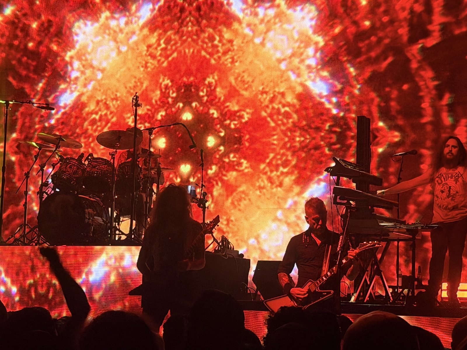 Mastodon on stage at the Hollywood Palladium under a red and orange video wall