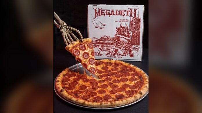 Megadeth Vic's Pepperoni pizza with a skeleton hand lifting a slice in front of the Pizza Sells custom Megadeth box from Prince St. Pizza