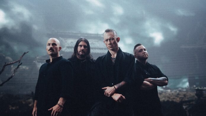 Trivium press photo for Crown In The Grave, the four members standing in front of a ruined Japanese temple under storm clouds